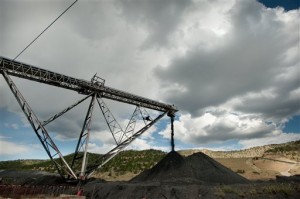 raw coal from a coal mine pours off of a conveyer belt, near Trinidad, Colo. A Colorado coal mine at the center of a legal fight over whether coal’s impact on climate change needs to be considered before it is mined is asking to keep mining while it appeals a federal court ruling. The Colowyo Coal Company has asked the 10th U.S. Circuit Court of Appeals in Denver to overturn a ruling requiring federal regulators to re-do their environmental review of operations at its mine near Craig, Colo., within four months. (Mark Reis/The Gazette via AP, File)