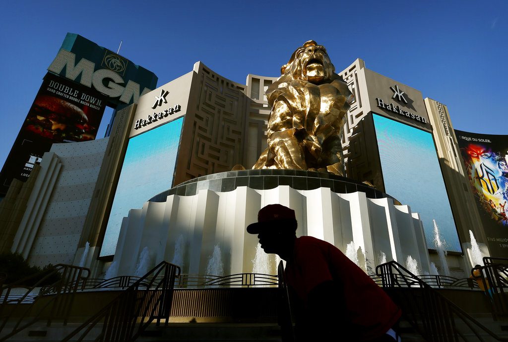 FILE - In this Aug. 3, 2015, file photo, a man rides his bike past the MGM Grand hotel and casino in Las Vegas. The operator of the Mandalay Bay casino-resort from which a gunman carried out the largest mass shooting in U.S. history has filed federal lawsuits against hundreds of victims. MGM Resorts International argues in lawsuits filed Friday, July 13, 2018 in Nevada and California that it is has “no liability of any kind” to the defendants under a federal law enacted in the wake of 9/11 terrorist attacks. (AP Photo/John Locher, File)