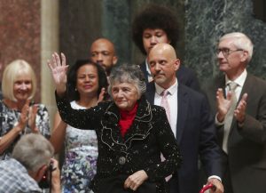 Supreme Court Justice Shirley Abrahamson, with her son, Daniel Abrahamson, right center, his wife, Tsan, and their son, Moses, 15, greets a crowd during a celebration in her honor in the rotunda at the Wisconsin State Capitol in Madison, Wis., Tuesday, June 18, 2019. Also standing with Abrahamson is Gov. Tony Evers, right, his wife, Kathy, left, and Lt. Gov. Mandela Barnes. (Amber Arnold/Wisconsin State Journal via AP)
