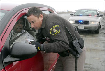 Racine County Sheriff's Deputy Ed Drewitz tickets a motorist stopped for speeding on I-94 near Racine recently. Drewitz' laser speed measuring device clocked the motorist at 80 mph. Drewitz said he cannot tell the driver's gender or racial characteristics or the car's license plate as he clocks speeders, sometimes at a distance of 1,600 feet. The Wisconsin state Senate has passed a repeal of a law that requires law enforcement agencies to collect data about the race of drivers they pull over in traffic stops. The vote to pass the bill Wednesday came with no Democrats present. (AP Photo/The Journal Times, Mark Hertzberg)