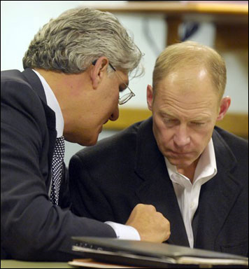 Curt Johnson (right), the former chairman of Diversey, Inc., consults with defense attorney Michael Hart as he is charged in Racine County Circuit Court Thursday in Racine with one count of repeated sexual assault of a child. (AP Photo/Journal Times, Mark Hertzberg)