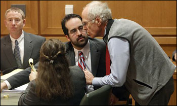 Wisconsin Secretary of State Doug La Follette (right) confers with assistant attorneys general Maria Lazar (foreground), and Steven Kilpatrick after a judge issued a temporary restraining order Friday barring the publication of a law that takes away most of the collective bargaining power from most state employees.