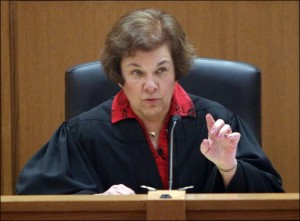 Judge Maryann Sumi listens to arguments during a hearing Friday in Dane County Curcuit Court in Madison. Sumi issued a temporary restraining order Friday barring the publication of a controversial new law that would sharply curtail collective bargaining for public employees. Sumi’s order will prevent Secretary of State Doug La Follette from publishing the law until she can rule on the merits of the case. 