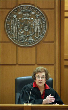 Judge Maryann Sumi issues a temporary restraining order barring the publication of a controversial new law that would sharply curtail collective bargaining for public employees Friday during a hearing in Dane County Court in Madison. The order will prevent Secretary of State Doug La Follette from publishing the law until she can rule on the merits of the case. Dane County Ismael Ozanne is seeking to block the law because he says a legislative committee violated the state's open meetings law. (AP Photo/Pool, Mark Hoffman)