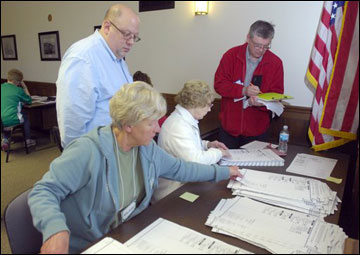 Observers Lou DAbbraccio (left) and Jim Deuster take notes as they watch tabulators sort ballots from the town of Burlington as a hand recount of ballots cast in the Wisconsin Supreme Court race begins Wednesday in the Racine County Courthouse. JoAnne Kloppenburg, who lost to incumbent Justice David Prosser by about 7,300 votes, asked for the recount. (AP Photo/Journal Times, Mark Hertzberg)