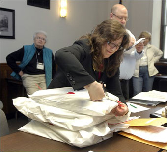 Lou D'Abbraccio takes notes as Racine County Clerk Wendy Christensen opens bags of ballots from the town of Burlington during a hand recount of ballots cast in the Wisconsin Supreme Court race. Incumbent David Prosser was officially declared the winner of the recount on Monday. (AP Photo/Journal Times, Mark Hertzberg)