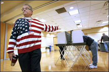 Election official Phillip Schlafer guides voters to polling booths at the Grand Chute Town Hall in Grand Chute. The Legislature on Thursday approved Gov Scott Walker's voter ID bill. (AP Photo/Post-Crescent, Dan Powers, File)