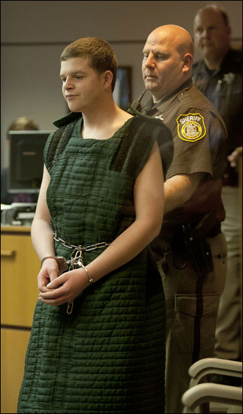 Richard Wilson, 17, is escorted into a hearing room May 10 at the Waukesha County Courthouse. Wilson was back in court Thursday for a hearing on his competency to stand trial. He is accused of murdering his grandfather, real estate developer Ron Siepmann, on May 8. (File photo by Kevin Harnack)