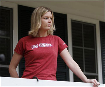 Holly Smith, 33, looks out from the porch of her home in Richmond, Va., after talking about her experiences in a child sex trafficking ring. A new report says 41 states have failed to adopt strong penalties against human trafficking, and advocates say a patchwork of differing state laws makes it difficult for authorities to target the crime. (AP Photo/Steve Helber)