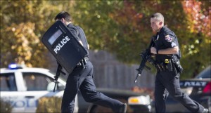 Police and swat team members respond to a call of a shooting at the Azana Spa in Brookfield, Wis. Sunday,Oct. 21, 2012. Multiple people were wounded when someone opened fire at the spa near the Brookfield Square Mall. Deputies are still looking for the gunman. (AP Photo/Tom Lynn)