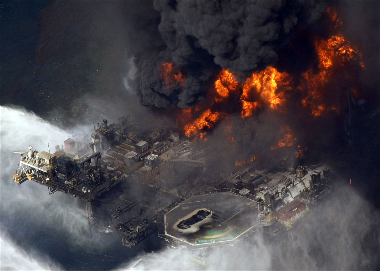 the Deepwater Horizon oil rig burns in the Gulf of Mexico. The Justice Department has reached a $1.4 billion settlement with Transocean Ltd., the owner of the drilling rig that sank after an explosion killed 11 workers and spawned the massive 2010 oil spill in the gulf. On Thursday, Jan. 3, 2013, two people with knowledge of the negotiations say Switzerland-based Transocean would pay the money to resolve the department's civil and criminal probe of the company's role in the Deepwater Horizon disaster. (AP File Photo/Gerald Herbert)