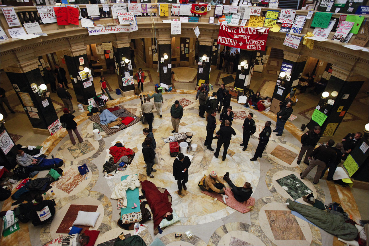 protests continuing at the state Capitol in Madison, Wis., as police and demonstrators gather on the rotunda floor where opponents to the governor's bill to eliminate collective bargaining rights for many state workers have been sleeping. The nation's labor unions suffered sharp declines in membership last year, the Bureau of Labor Statistics said Wednesday, led by losses in the public sector as cash-strapped state and local governments laid off workers and _ in some cases _ limited collective bargaining rights. (AP File Photo/Andy Manis)