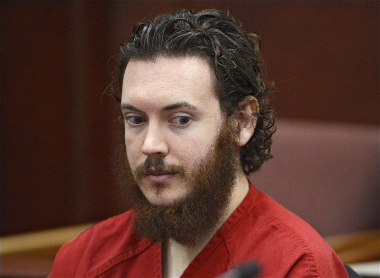 Aurora theater shooting suspect James Holmes in court in Centennial, Colo. Holmes is scheduled Tuesday, June 25, 2013 at a hearing where the judge overseeing the Colorado theater shooting case will reconsider the timing of the trial and other proceedings. (AP Photo/The Denver Post, Andy Cross, Pool,File)