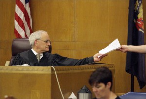 Judge Timothy Van Akkeren receives the vedict from the bailiff in Nathan Paape's murder trial, Thursday June 20, 2013 in Sheboygan, Wis. A jury has convicted Nathan Paape, a 14-year-old Wisconsin boy in the bludgeoning death of his friend's great-grandmother. (AP Photo/The Sheboygan Press, Bruce Halmo)