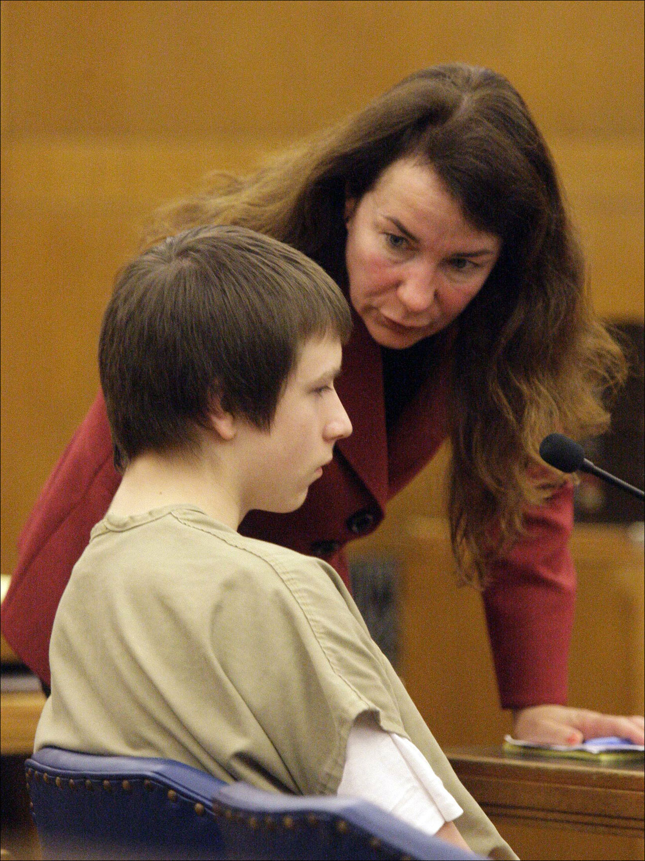 Defense attorney June Spoerl talks with Nathan Paape, 14, as he appears Wednesday June 12, 2013, at a motion hearing for his murder trial in Sheboygan, Wis. Jury selection for Paape is set to begin Friday, June 14, 2013 in Sheboygan, Wisc. Paape and Antonio Barbeau were both charged as adults in the September slaying of Barbeau's great-grandmother. Barbeau pleaded no contest earlier this month to a charge of first-degree homicide. (AP Photo/The Sheboygan Press, Bruce Halmo)