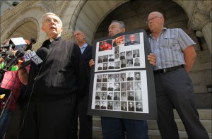 Father Jim Connell, left, the former vice chancellor of the Archdiocese of Milwaukee stands with Peter Isely, second from left, the Midwest Director of SNAP, The Survivors Network of Those Abused by Priests, and victims, Arthur Budzinski, of West Allis, Wis., and Kevin Wester, right, while addressing the media regarding release of Milwaukee priest sex abuse files on the steps of the the U.S. Federal Courthouse in Milwaukee on Monday, July 1, 2013. Budzinski holds a poster of the 45 priests named on the archdiocese's website as having substantiated allegations of sexually abusing at least one minor. (AP Photo/Milwaukee Journal-Sentinel,Mike De Sisti)