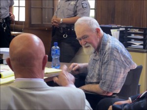 John Henry Spooner, 76, right, confers with his defense attorney Monday, July 15, 2013, during a break in jury selection for his trial on charges that he fatally shot a black teen last year whom he suspected of breaking into his Milwaukee home and stealing weapons. The case has drawn comparisons to the trial of George Zimmerman, who was acquitted two days earlier of killing Trayvon Martin in Sanford, Fla., last year. (AP Photo/Dinesh Ramde)