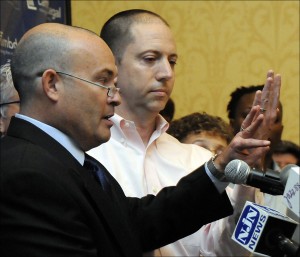 Danny Weiss, left, and John Grant of Asbury Park, N.J. hold up their wedding rings during a news conference on a same-sex marriage lawsuit filed in Trenton, N.J. A New Jersey judge could rule Thursday, Aug. 14, 2013 that the state must recognize gay marriage as part of the fallout from a June ruling by the U.S. Supreme Court that struck down a ban on giving federal benefits to married same-sex couples. (AP Photo/MJ Schear, File)