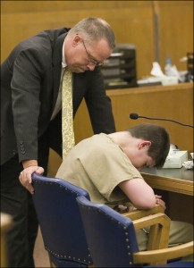 Defense Attorney George Limbeck, left, consoles Antonio Barbeau, 14, as he cries following a life sentence handed down in Sheboygan County Circuit Court Branch 2 Monday August 12, 2013 in Sheboygan, Wisc. Barbeau had pleaded no contest to first-degree intentional homicide in the September 2012 death of Barbara Olson. (AP Photo/Sheboygan Press Media, Gary C. Klein)