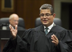 Ruben Castillo, the new chief judge of the U.S. District Court in Chicago, gives concluding remarks after being sworn in as chief judge. Castillo has questioned whether the federal government in a drug case racially profiled African-Americans and Latinos. In a decision posted late Wednesday, July 31, 2013, Castillo wrote that since 2011, 19 African-Americans and seven Latinos have been charged in drug stings in the Chicago area, in which agents used an informant to talk suspects into robbing a fake stash house. (AP Photo/Scott Eisen, File)