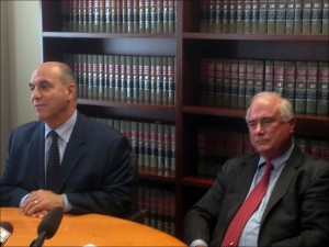 Union attorneys Lester Pines, left, and Timothy Hawks address the media during a news conference at Pines' Madison, Wis., law offices, Tuesday, Sept. 24, 2013 after filing a motion asking a judge to find state labor relations officials in contempt of court. The attorneys allege the state is continuing to enforce parts of Gov. Scott Walker's collective bargaining restrictions despite a ruling that they're unconstitutional. (AP Photo/Todd Richmond)