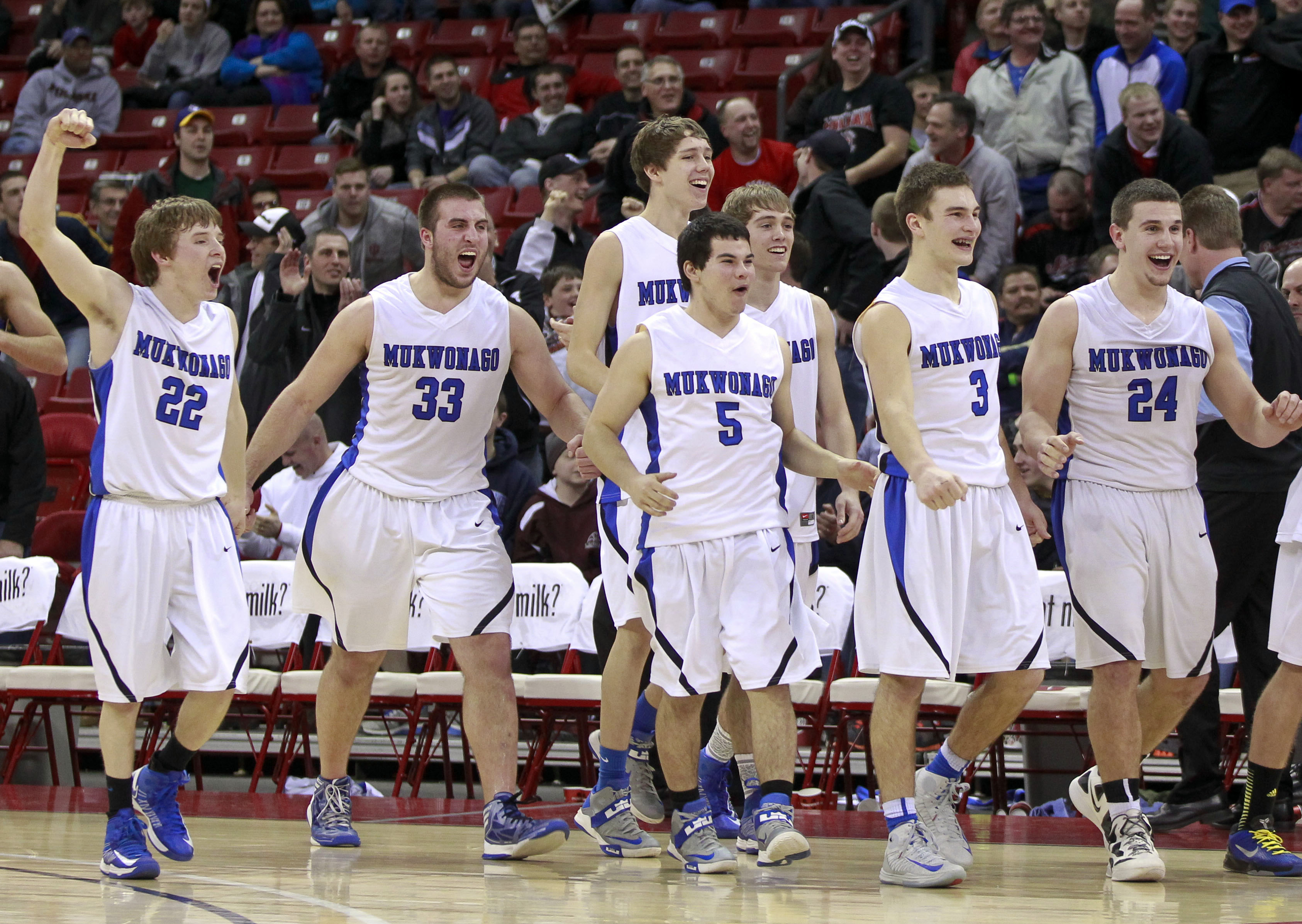 Mukwonago Indians teammates celebrate their 64-47 win over Milwaukee King in a Division 1 semifinal WIAA high school basketball game in Madison, Wis. The Wisconsin state Senate is set to vote on a bill that would make it harder to force public schools to drop American Indian nicknames and logos. (AP Photo/Andy Manis, File)