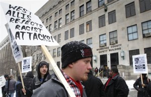 Cody Misiak, of West Allis, Wis., carries a sign during a protest demanding justice for Corey Stingley, outside of District Attorney John Chisholm's office in the Safety Building, in Milwaukee, Friday, Jan. 17, 2014. Stingley, 16, died in 2012 after being restrained by three men in a convenience store after being suspected of shoplifting alcohol. Milwaukee County district attorney John Chisholm conducted a yearlong investigation but said last week he wouldn't charge any of the three men with homicide or reckless conduct. (AP Photo/Milwaukee Journal-Sentinel, Gary Porter)