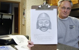 Tim Ewing, a retired sketch artist for the Washington County Sheriff's Department, holds up one of his many composite sketches from 1994 at his home in West Bend. For nearly 16 of his 27 years at the sheriff's department he created sketches of suspects that lead to arrests. (AP Photo/Rhinelander Daily News, John Ehlke)