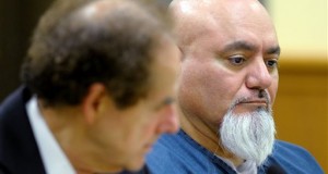 Javier Garcia, right, listens during his sentencing in Kenosha, Wis. Garcia, convicted of strangling a woman in 2012 and leaving her body in a cemetery. was sentenced to life in prison, and a judge denied the possibility of parole after he continued to insist he was innocent. (AP Photo/The Kenosha News, Sean Krajacic)
