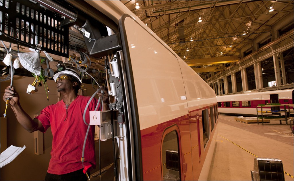 James Cannon, an electrician at Talgo Inc., installs wiring for lights in a high-speed rail car at the facility in Milwaukee in 2010. Wisconsin will pay the Spanish manufacturer $9.75 million for two trains it built that were never used after Gov. Scott Walker abandoned a rail project. (File photo by Kevin Harnack)