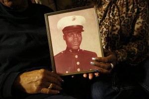 a picture of Jerome Murdough is held by his mother Alma Murdough left, and sister Cheryl Warner at Alma Murdough's home in the Queens borough of New York. The homeless former Marine died in February in a Rikers Island jail cell that multiple city officials say was at least 100 degrees when his body was discovered.(AP Photo/Jason DeCrow, File)