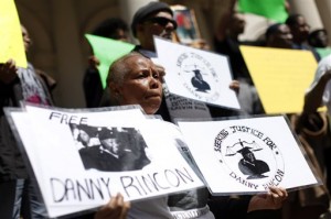 family members of inmates who claim they were wrongfully convicted gather to show support as a group of New York City men, who claimed they were framed by a crooked police detective decades ago, voiced their demand for prosecutors to speed up an ongoing review of the detective's cases at a rally on the steps of City Hall in New York. When three half brothers’ decades-old murder convictions were thrown out last month, they became a dramatic example of an idea spreading among prosecutors nationwide: “integrity units” dedicated to double-checking convictions to determine whether justice was served. (AP Photo/Jason DeCrow, File)