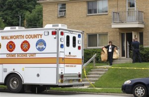Walworth County investigators carry bags full of material from an apartment in West Allis, Wis., after picking up a suspect allegedly involved in two murders where the bodies were found in suitcases along a rural road in Geneva Township several weeks ago. (AP Photo/Milwaukee Journal-Sentinel, Gary Porter)