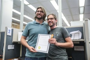 Craig Bowen, left, and Jake Miller pose with their certificate of marriage, before becoming the first gay couple married by Marion County Clery Beth White in Indianapolis, Wednesday, June 25, 2014. A federal judge struck down Indiana's ban on same-sex marriage Wednesday in a ruling that immediately allowed gay couples to wed. (AP Photo/The Indianapolis Star, Michelle Pemberton)