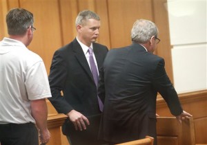 Campbell Police Chief Tim Kelemen, center, pleaded no contest Friday July 25, 2014 to a charge that he signed a local tea party leader up on gay dating, pornography and federal health care websites in La Crosse, Wis. (AP Photo/Rory O'Driscoll, La Crosse Tribune)