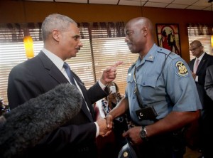 Attorney General Eric Holder talking with Capt. Ron Johnson of the Missouri State Highway Patrol at Drake's Place Restaurant in Florrissant, Mo. As the Justice Department probes the police shooting of an unarmed 18-year-old in Ferguson, Missouri, history suggests there’s no guarantee of a criminal prosecution, let alone a conviction. Federal authorities investigating possible civil rights violations in the Aug. 9 death of Michael Brown must meet a difficult standard of proof, a challenge that has complicated the path to prosecution in past police shootings. (AP Photo/Pablo Martinez Monsivais, File-Pool)