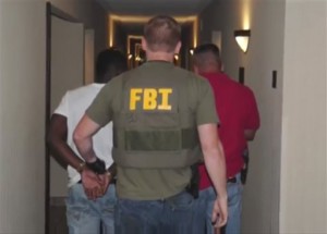 authorities raid a hotel in Jackson, Mississippi. When FBI agents and police officers fanned out across the country last month in a weeklong effort to rescue child sex trafficking victims, they pulled kids as young as 11 from dingy motel rooms, truck stops and homes. (AP Photo/FBI)