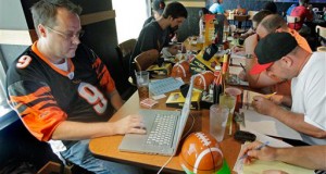 In this Aug. 30, 2010 photograph, Brian Sherman, left, uses his laptop to record moves in his team's fantasy football draft, at a Buffalo Wild Wings restaurant in Cincinnati. Some restaurant chains around the country have launched promotional drives to score with dedicated players of the growing pastime. (AP Photo/Al Behrman)