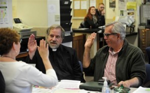 Tony Larsen, 65, pastor at Olympia Brown Unitarian Universalist Church, left, and partner Craig Matheus, 62, verify their vital information with Joanne Smith, deputy clerk as they apply for a marriage license on Monday, Oct. 6, 2014 in the County Clerk's office inside the Racine County Courthouse in Racine, Wis. The Racine County Clerk's office began taking applications for marriage licenses at about noon Monday after the U.S. Supreme Court rejected the appeal of a lower court ruling. (AP Photo/The Journal Times, Soctt Anderson)