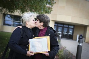Deb Monicken and Sue Kattas kiss as they hold their marriage license, which they received this summer during a brief lifting of the same-sex marriage ban in June, at the courthouse in Hudson, Wis., Monday, Oct. 6, 2014. Their marriage is now recognized in Wisconsin where they live after the U.S. Supreme court declined to hear appeals from several states seeking to ban same-sex marriage on Monday. (AP Photo/The Star Tribune, Renee Jones Schneider)