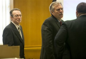 Joseph Reinwand, left, looks on as his public defenders David Dickman, center, and Troy Nielsen, right, talk before the first day of the Reinwand homicide trial at Wood County Courthouse in Wisconsin Rapids, Wisc. Jolynn Reinwand testified that she doesn't remember having a key to the home where prosecutors say her father, Joseph Reinwand, killed her ex-boyfriend. (AP Photo/The Marshfield News-Herald, Megan McCormick)