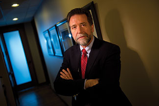 Ray Dall’Osto, a criminal defense attorney with Gimbel, Reilly, Guerin & Brown LLP, Milwaukee, stands in firm’s hallway Nov. 14. Dall’Osto opposes Wisconsin’s truth-in-sentencing law, saying that a prisoner with no chance of parole is more likely to re-offend.