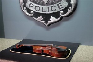 a $5 million Stradivarius violin is displayed at the Milwaukee Police Department in Milwaukee, a day after police recovered the instrument stolen on Jan. 27, 2014 from a concertmaster. Salah Salahadyn faces up to 15 years when he is sentenced Monday, Nov. 9, 2014 after pleading guilty to robbery for snatching 300-year-old violin from a musician who was attacked with a stun gun following a performance in Milwaukee. (AP Photo/Dinesh Ramde, File)