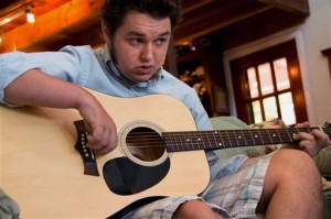 Jeffrey McCord, who suffered from violent and unexplained seizures as a baby, demonstrates his guitar at home in St. John, Virgin Islands. A neurologist drew a connection that a dozen other doctors missed: his convulsions began days after a routine vaccination. Jeffrey's mother Martha filed a claim with a congressional program that compensates children like Jeffrey, but it took 11 years for the first check to arrive. (AP Photo/William Stelzer)