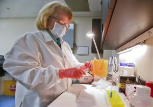 Barbara Crim-Swanson, a biology supervisor at the Kansas Bureau of Investigation, demonstrates how a sexual assault kit is tested in a KBI laboratory in Topeka, Kan. The Kansas Bureau of Investigation recently sent surveys to all Kansas law enforcement agencies to identify if there is a testing backlog for the kits, which include swabs and specimens gathered during exams of sexual assault victims. (AP Photo/The Topeka Capital Journal, Chris Neal)
