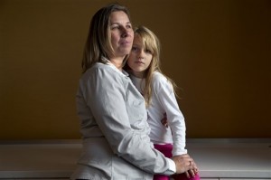 Peggy Young, of Lorton, Va., with her daughter Triniti, 7, in Washington. Peggy Young has only to look at her 7-year-old younger daughter to be reminded how long she has been fighting with United Parcel Service over its treatment of pregnant employees, and why. Young was pregnant when the company told her she could not have a temporary assignment to avoid lifting heavy packages, as her doctor ordered. She sued UPS for discriminating against pregnant women and, after losing two rounds in lower courts, the Supreme Court will hear her case Wednesday. (AP Photo/Jacquelyn Martin)