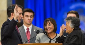 Wisconsin Gov. Scott Walker, left, takes the oath of office from Shirley Abrahamson, Chief Justice of the Wisconsin Supreme Court, during Walker's inauguration ceremony at the Capitol, Monday, Jan. 5, 2015, in Madison, Wis. Pictured behind the governor are his son Alex and wife, Tonette. (AP Photo/Andy Manis)