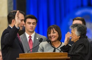 Wisconsin Gov. Scott Walker, left, takes the oath of office from Shirley Abrahamson, Chief Justice of the Wisconsin Supreme Court, during Walker's inauguration ceremony at the Capitol, Monday, Jan. 5, 2015, in Madison, Wis. Pictured behind the governor are his son Alex and wife, Tonette. (AP Photo/Andy Manis)