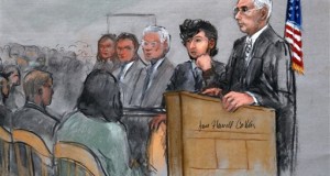 Boston Marathon bombing suspect Dzhokhar Tsarnaev, second from right, is depicted with his lawyers, left, beside U.S. District Judge George O'Toole Jr., right, as O'Toole addresses a pool of potential jurors in a jury assembly room at the federal courthouse, Monday, Jan. 5, 2015, in Boston. Tsarnaev is charged with the April 2013 attack that killed three people and injured more than 260. His trial is scheduled to begin on Jan. 26. He could face the death penalty if convicted. (AP Photo/Jane Flavell Collins)