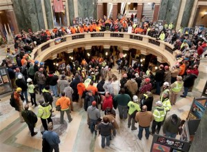 Labor workers gather in the rotunda of the Wisconsin State Capitol as state legislators consider a proposed right-to-work bill in Madison, Wis. Tuesday, Feb. 24, 2015. Opponents of a Republican push to turn Wisconsin into a right-to-work state began to converge on the Capitol on Tuesday for a rally and to testify against the fast-tracked measure. (AP Photo/John Hart, Wisconsin State Journal)